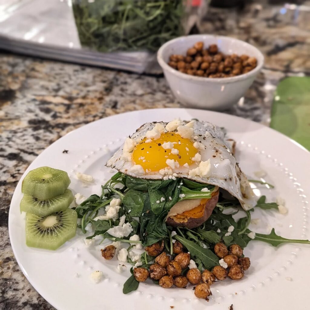 duck egg on spinach on a white plate.