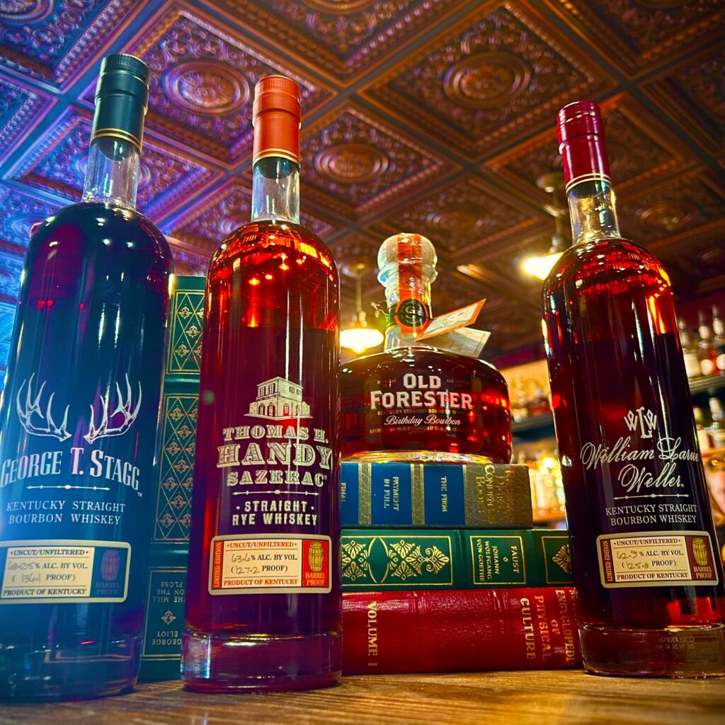 Top shelf liquors on top of books. Photo: Liquid Library.