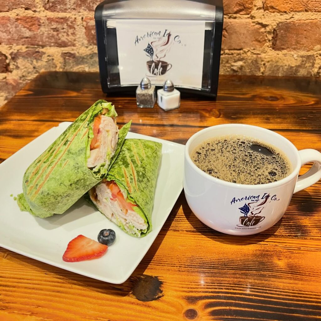 a wrap sandwich and a coffee cup
