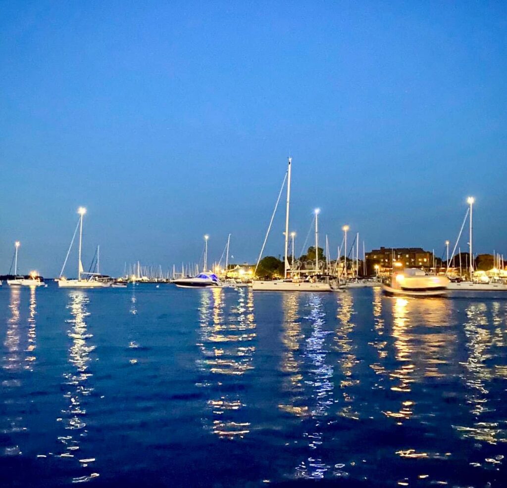 View of Annapolis Harbor at night with boats in the horizon
