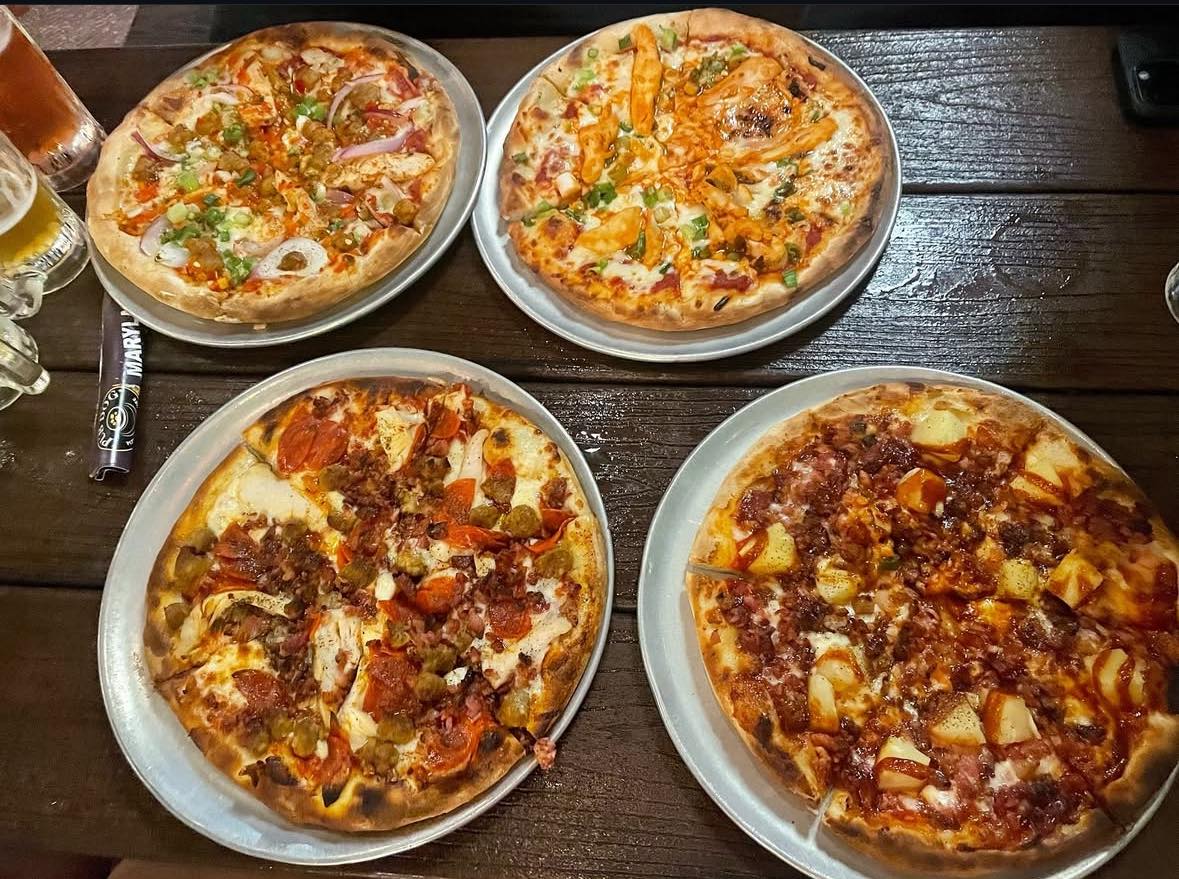 Various pizzas on a table