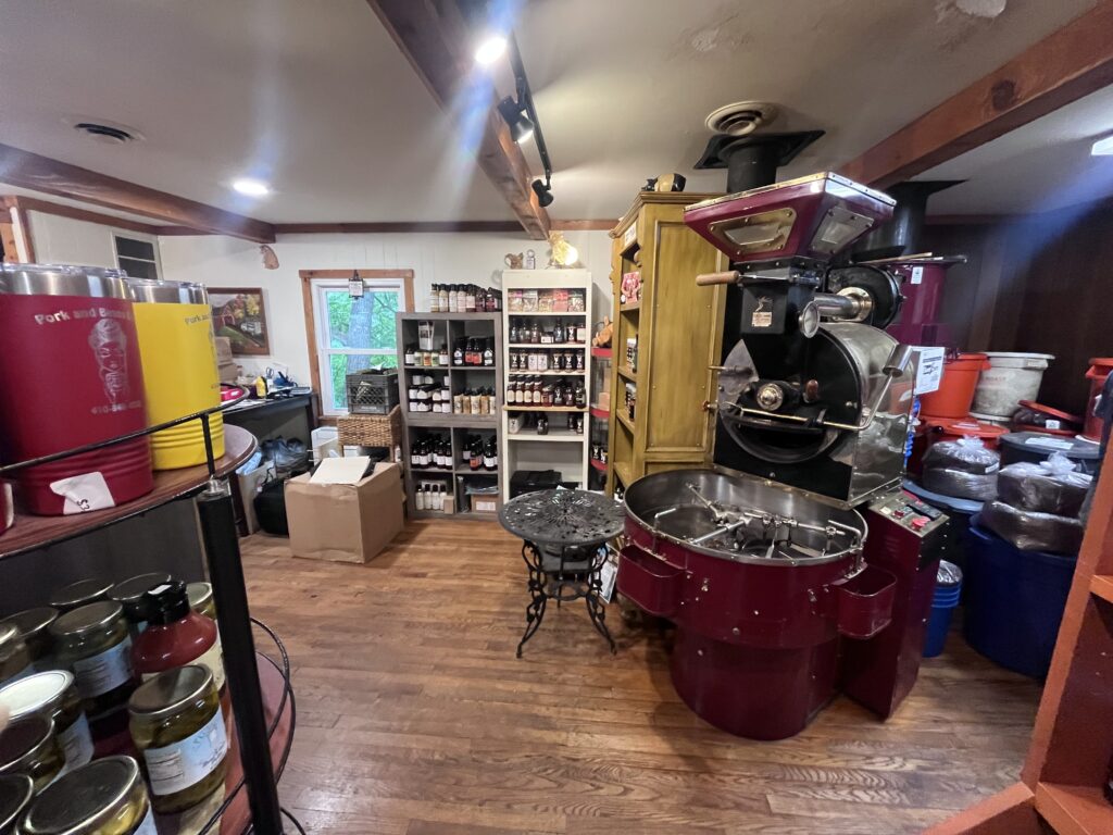 Coffee roaster  in store surrounded by items for sale